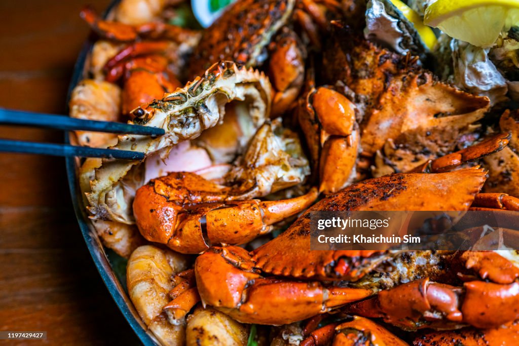 Seafood barbecue platter, focus on crab