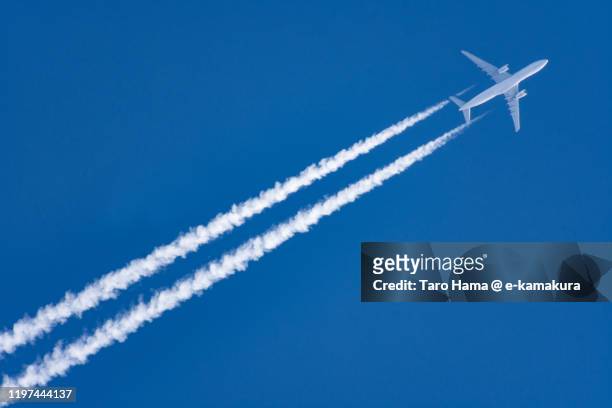 the airplane flying in the blue sky in japan - 飛行機 ストックフォトと画像