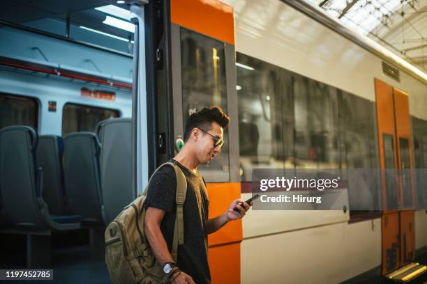 hipster man leaving subway train - underground station stock pictures, royalty-free photos & images