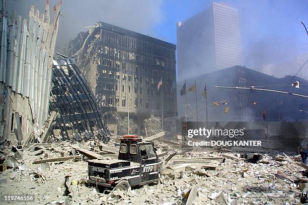 Police scooter sits in the rubble in lower Manhattan 11 September in New York after two planes flew into the World Trade Center twin towers. Both...