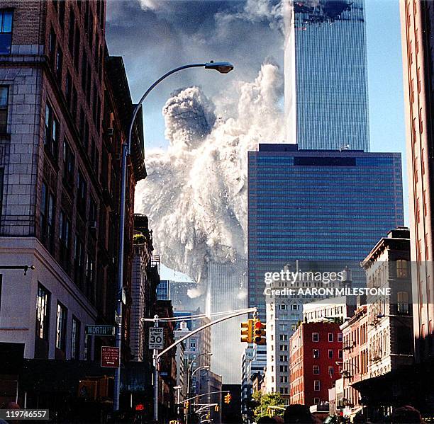 The south tower of the World Trade Center collapses sending dust and smoke into the streets 11 September in New York. Two planes crashed into the...