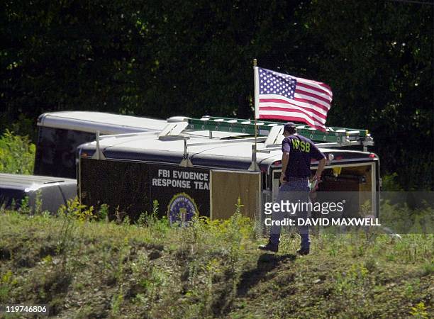 National Transportation Safety Board worker walks by an FBI trailer at the crash site of United Airlines Flight 93 in Shanksville, PA,12 September...