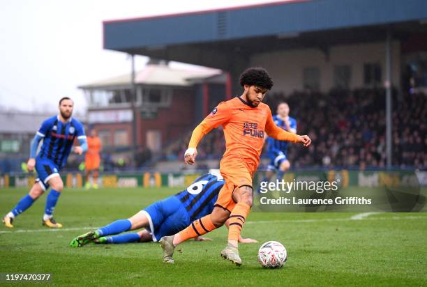 Deandre Yedlin of Newcastle United runs past Eoghan O'Connell of Rochdale during the FA Cup Third Round match between Rochdale AFC and Newcastle...