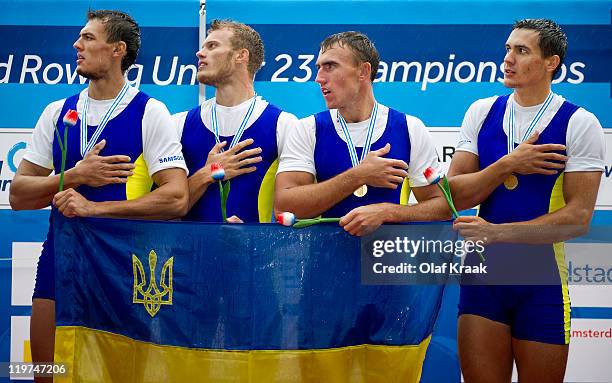 Ivan Dovgodko, Olexandr Nadtoka, Ivan Futryk and Yurly Ivanov of Ukraine celebrate on the winners podium after winning the Men's Quadruple Sculls...