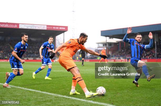 Joelinton of Newcastle United crosses the ball under pressure from Jimmy Ryan of Rochdale during the FA Cup Third Round match between Rochdale AFC...