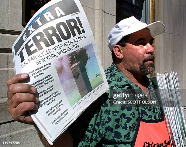Newspaper vendor Carlos Mercado sells the "Extra" editon of the Chicago Sun-Times printed 11 September after the terrorist attacks on the United...