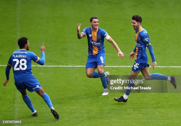 Sean Goss of Shrewsbury Town celebrates with Oliver Norburn and Josh Laurent after scoring his team's first goal during the FA Cup Third Round match...