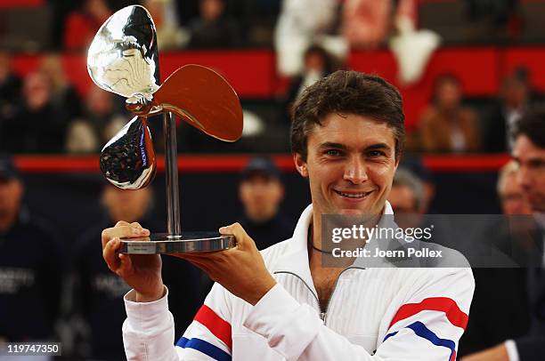 Gilles Simon of France celebrates with the cup after winning his final match against Nicolas Almagro of Spain during the bet-at-home German Open...