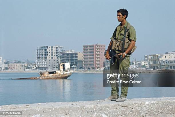 An Israeli soldier stands on the harbour wall after the army captured the Lebanese port city of Sidon during the Israeli army invasion named...