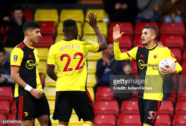 Roberto Pereyra of Watford celebrates with teammates after scoring his team's third goal during the FA Cup Third Round match between Watford FC and...