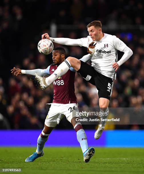 Alfie Mawson of Fulham battles for possession with Jonathan Kodija of Aston Villa during the FA Cup Third Round match between Fulham FC and Aston...