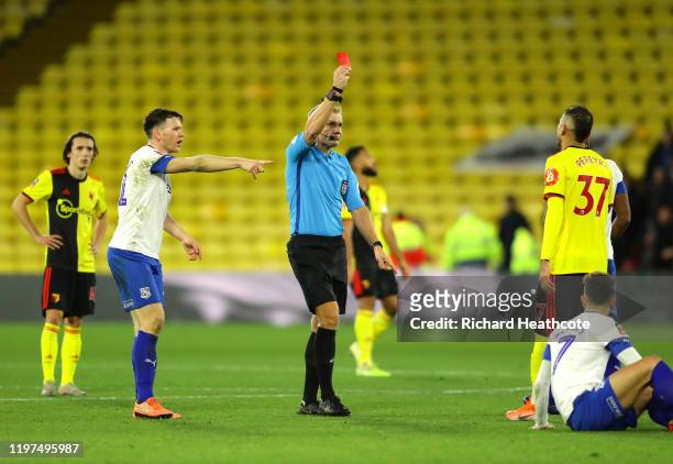 Match Referee Graham Scott shows a red card to Roberto Pereyra of Watford during the FA Cup Third Round match between Watford FC and Tranmere Rovers...