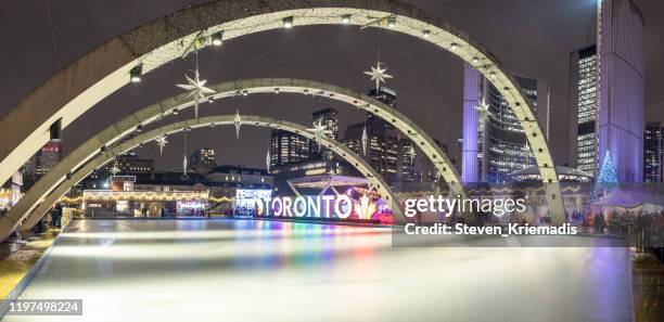 toronto city hall - nathan phillips square at christmas time - nathan phillips square stock pictures, royalty-free photos & images