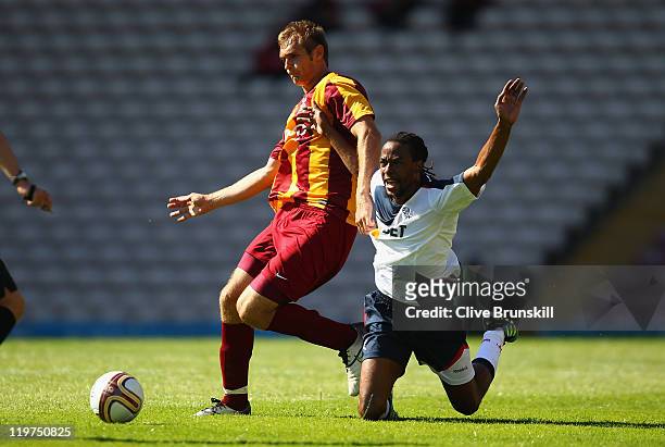 Ricardo Gardner of Bolton Wanderers falls whilst in action with James Hanson of Bradford City during the pre season friendly match between Bradford...