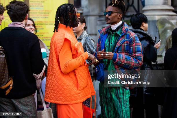 Guests seen wearing orange vest, jumper, sunglasses and checked down feather jacket, green jacket and pants with jungle print outside Jordan Luca...
