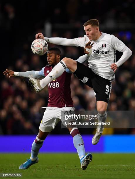 Alfie Mawson of Fulham challenges Jonathan Kodjia of Aston Villa during the FA Cup Third Round match between Fulham and Aston Villa at Craven Cottage...