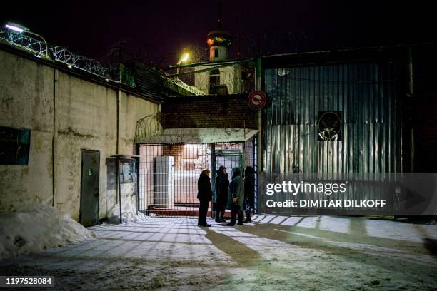 Women gather by the entrance to the penal colony ?1 in the settlement of Novoye Grishino outside the town of Dmitrov in Moscow region on January 30,...