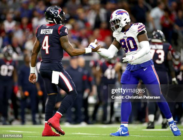 Deshaun Watson of the Houston Texans and Shaq Lawson of the Buffalo Bills shakes hands during the second quarter of the AFC Wild Card Playoff game at...