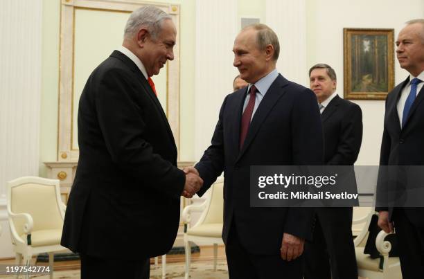 Russian President Vladimir Putin greets Israeli Prime Minister Benjamin Netanyahu dduring their meeting at the Kremlin on January 30, 2020 in Moscow,...