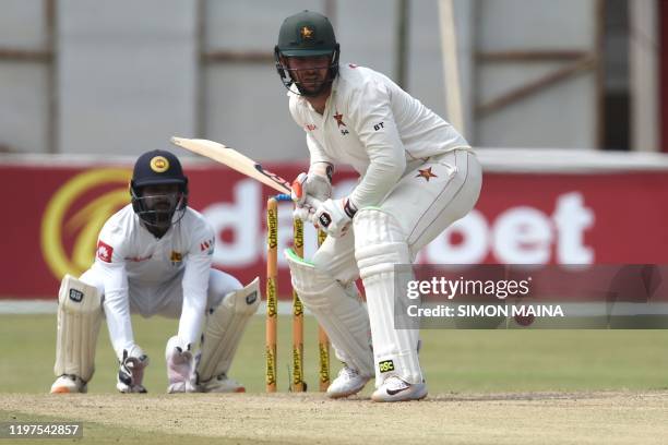 Zimbabwe's Brendan Taylor prepares to play a shot as Sri Lanka's Niroshan Dickwella looks on during the fourth day of the second Test cricket match...