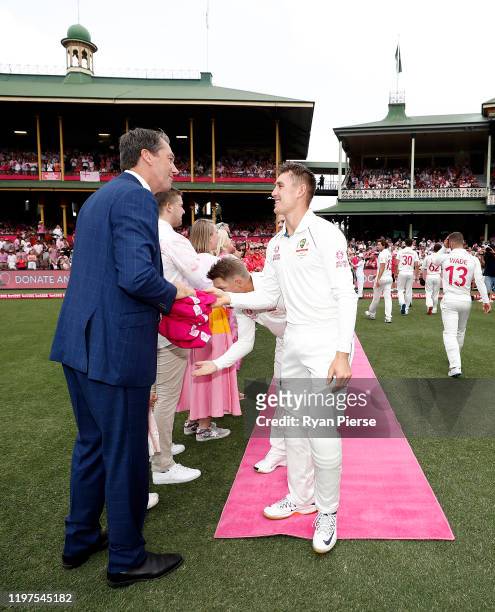 Marnus Labuschagne of Australia presents his Pink Cap to Glenn McGrath on Jane McGrath Day during day three of the Third Test match in the series...