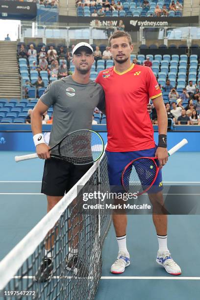 Alexander Cozbinov of Moldova and Dimitar Kuzmanov of Bulgaria pose at the net after the coin toss during their Group C singles match during day...