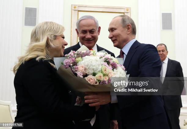 Russian President Vladimir Putin greets Israeli Prime Minister Benjamin Netanyahu and his wife Sara Netanyahu dduring their meeting at the Kremlin on...