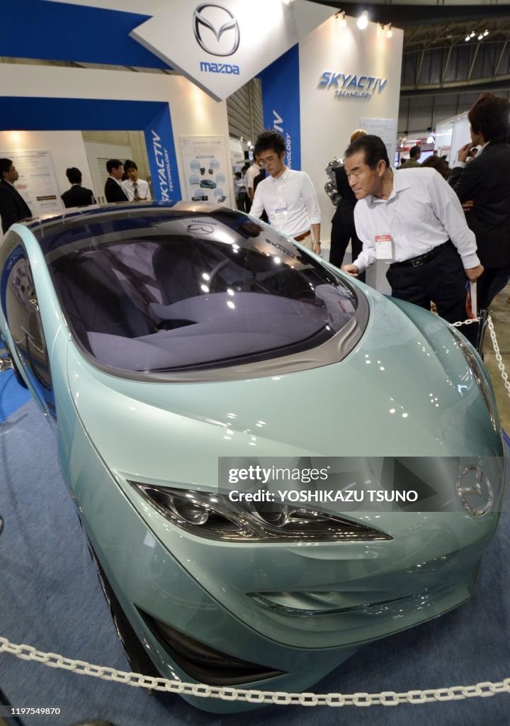 Mazda In Japan Visitors look at Mazda's concept vehicle