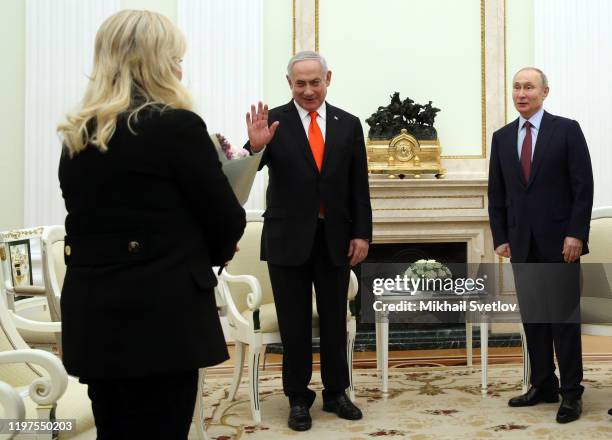 Russian President Vladimir Putin greets Israeli Prime Minister Benjamin Netanyahu and his wife Sara Netanyahu dduring their meeting at the Kremlin on...