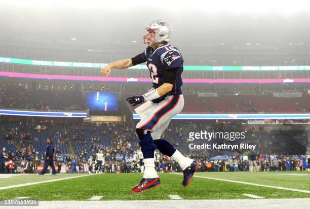 Tom Brady of the New England Patriots reacts as he runs onto the field before the AFC Wild Card Playoff game against the Tennessee Titans at Gillette...