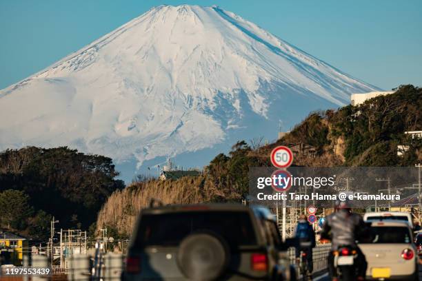 snow-capped mt. fuji and coast road in kanagawa prefecture of japan - car and motorcycle on mountain road stock pictures, royalty-free photos & images