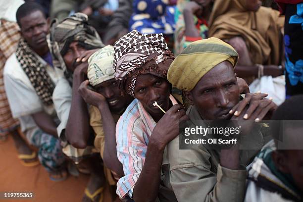 Somali refugees wait at the entrance to the registration area of the Ifo refugee camp which makes up part of the giant Dadaab refugee settlement on...