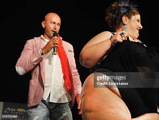 Host and former football player Stefano Bettarini dances with a participant during the 22nd edition of the Italian 'Miss Cicciona' on July 23, 2011...