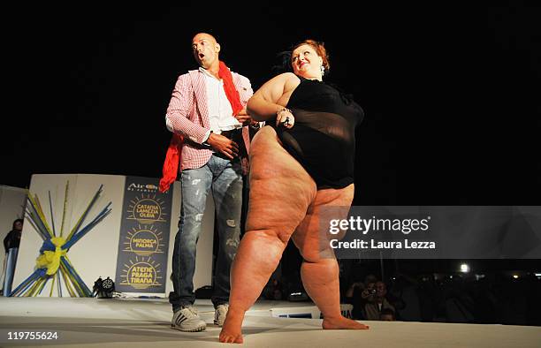 Host and former football player Stefano Bettarini dances with a participant during the 22nd edition of the Italian 'Miss Cicciona' on July 23, 2011...