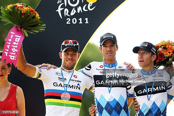 Thor Hushovd, David Millar and Christain Vandevelde of team Garmin Cervelo celebrate on the podium after winning the best team prize during the...