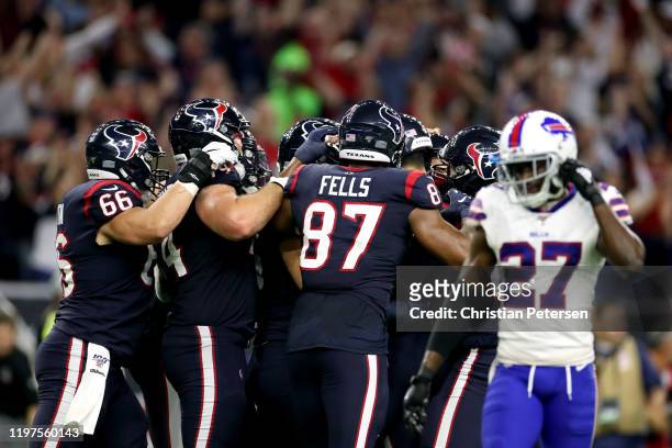Ka'imi Fairbairn of the Houston Texans is congratulated by his teammates after his game-winning field goal in overtime to give his team the 22-19 win...
