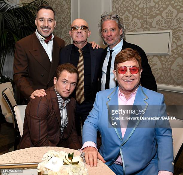 David Furnish, Bernie Taupin and Dexter Fletcher. Taron Egerton and Elton John attend The BAFTA Los Angeles Tea Party at Four Seasons Hotel Los...