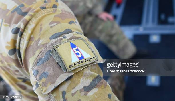 Unit patch from the from the 5th Aviation Regiment is seen on the sleeve of Australian Army soldier as he walks onto a CH-47 Chinook before it...