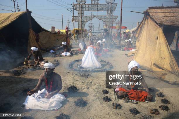 Devotees perform a ritual by burning dried cow dung cakes at sangam, confluence of Rivers Ganges, Yamuna and mythical Saraswati , on the auspicious...
