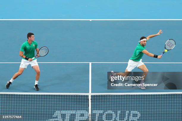 Grigor Dimitrov and Alexander Lazarov of Bulgaria play a shot during their Group C doubles match against Radu Albot and Alexander Cozbinov of Moldova...