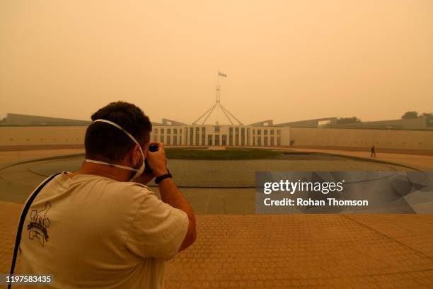 Photographer captures smoke at Parliament House on January 05, 2020 in Canberra, Australia. Smoke haze across Eastern Australian cities has become...