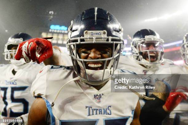 Logan Ryan of the Tennessee Titans celebrates his touchdown with teammates against the New England Patriots in the fourth quarter of the AFC Wild...