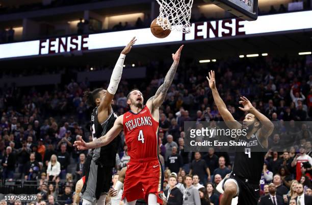Redick of the New Orleans Pelicans makes the game winning shot over Richaun Holmes and Cory Joseph of the Sacramento Kings in the final seconds of...
