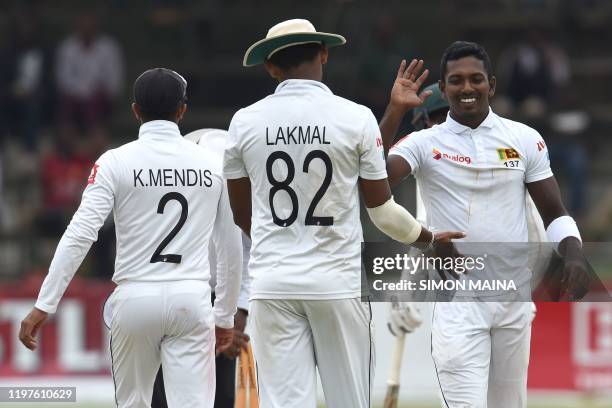 Sri Lanka's Vishwa Fernando is congratulated by teammate after his dismissal of Zimbabwe's Sikandar Raza during the fourth day of the second Test...