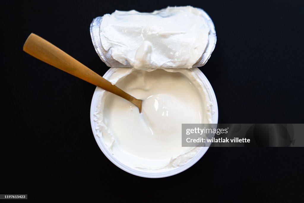 Yogurt in bowl on wooden table. healthy eating