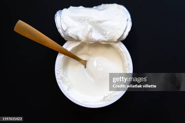 yogurt in bowl on wooden table. healthy eating - yogurt foto e immagini stock