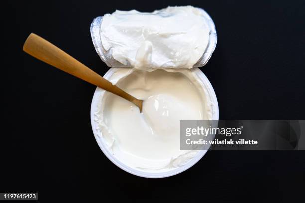 yogurt in bowl on wooden table. healthy eating - yogurt stock pictures, royalty-free photos & images