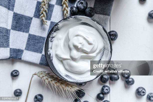 yogurt in bowl on wooden table. healthy eating - greek yogurt stock pictures, royalty-free photos & images