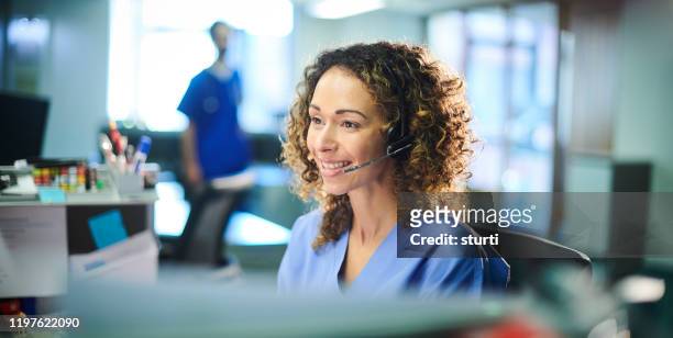 smiling medical customer service rep - switchboard operator stock pictures, royalty-free photos & images