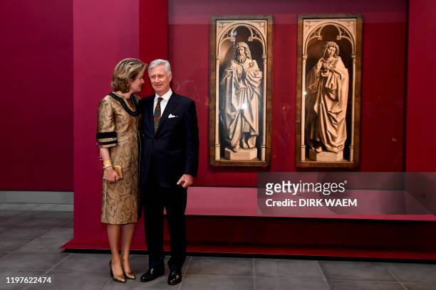 Queen Mathilde of Belgium and King Philippe - Filip of Belgium pose in front of two panels of the Mystic Lamb , showing John the Baptist and Saint...